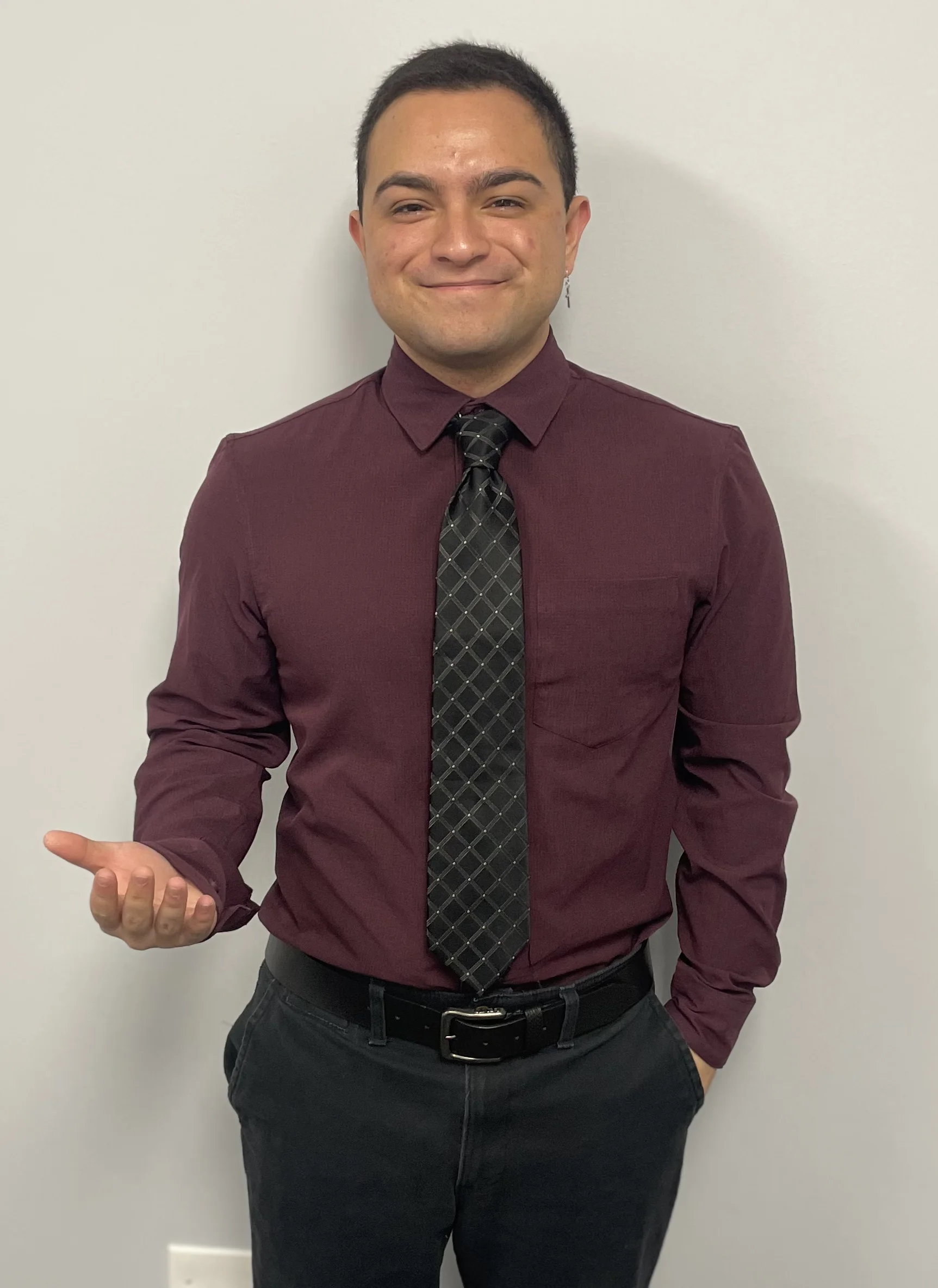 Donald Wilkin in a burgundy dress shirt and tie