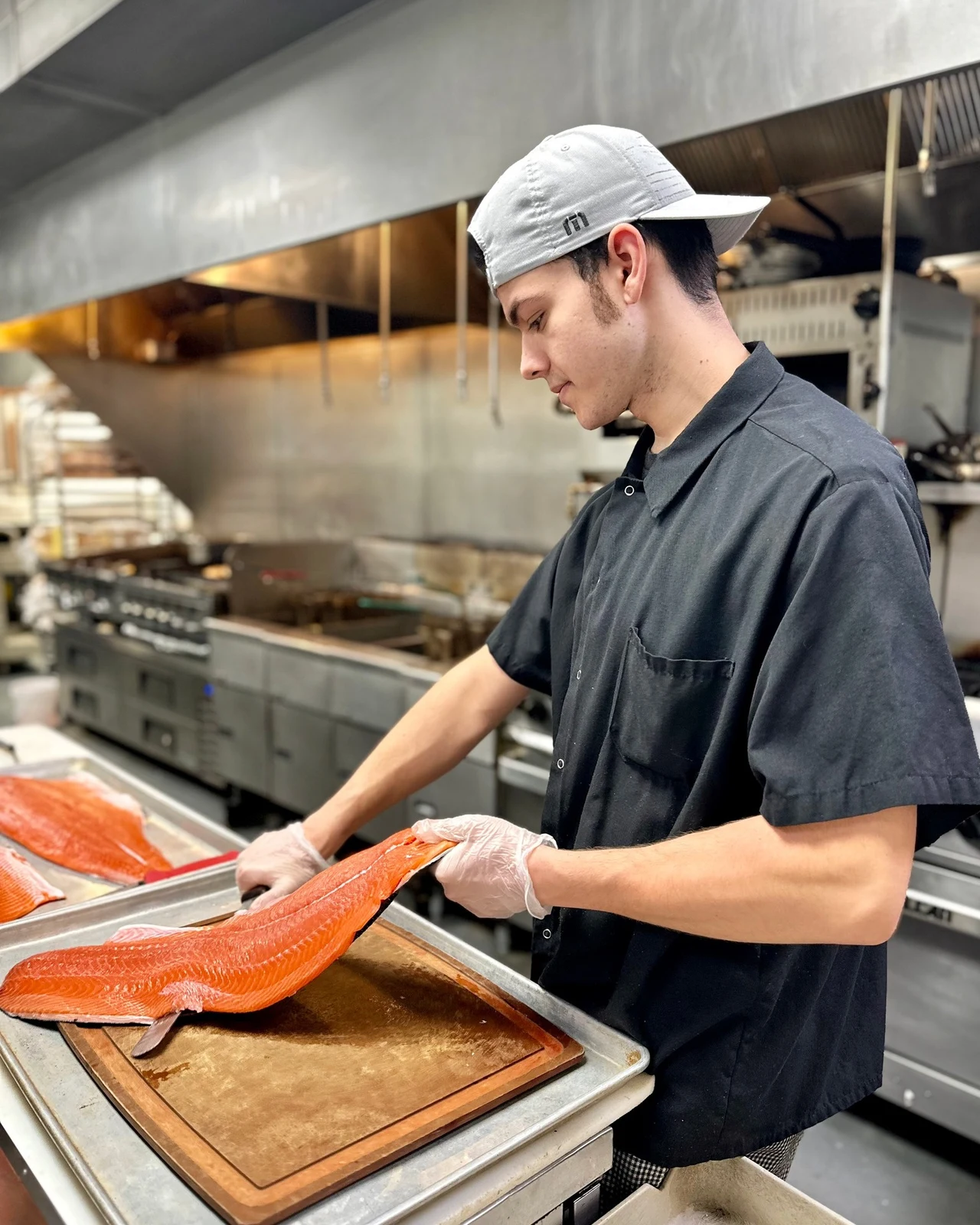 Commercial culinary photography of kitchen chef preparing food at work surface