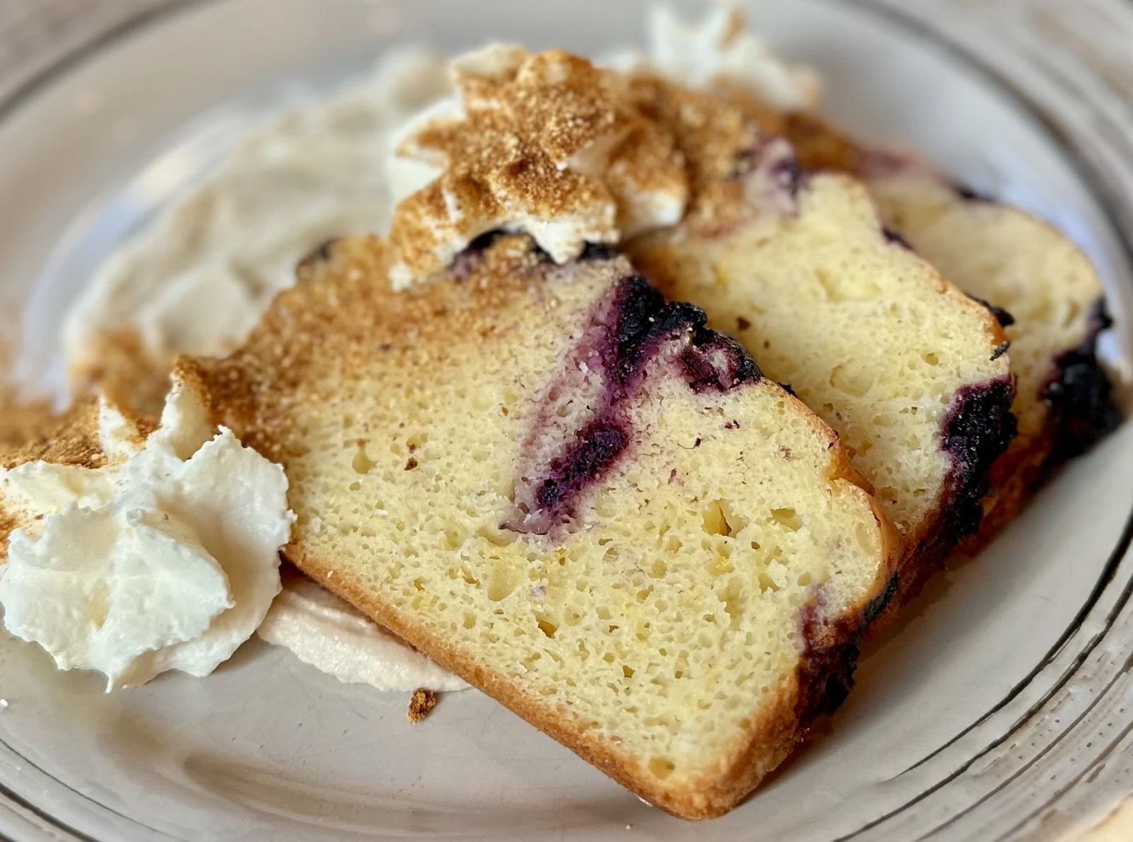 Dessert photography of berry loaf cake with cream on plate