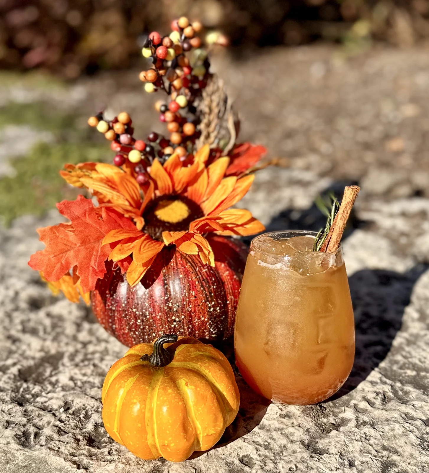 Seasonal content photography of autumn cocktail with pumpkins and floral arrangement