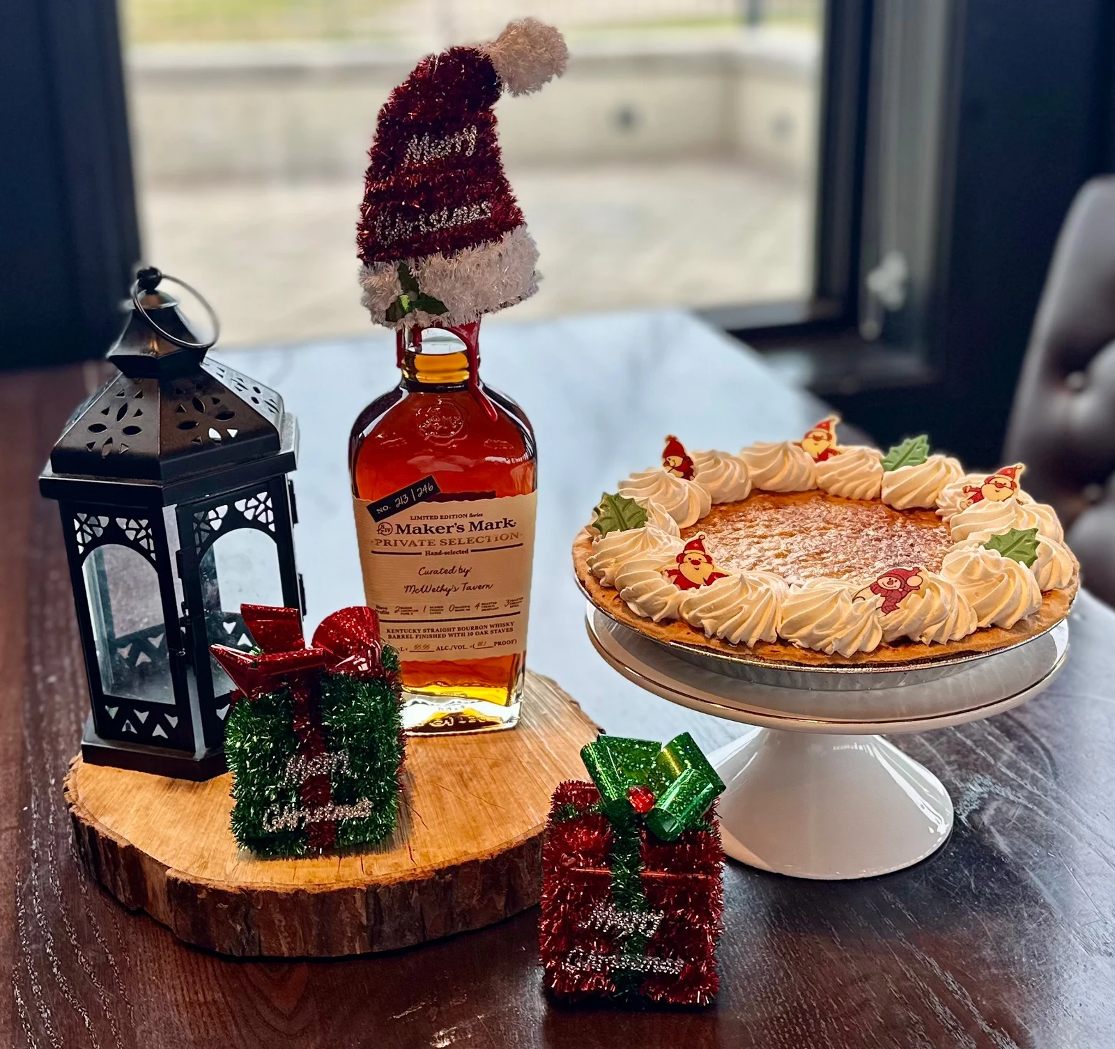 Brand photography of branded whiskey bottle, lanterns and pie arrangement