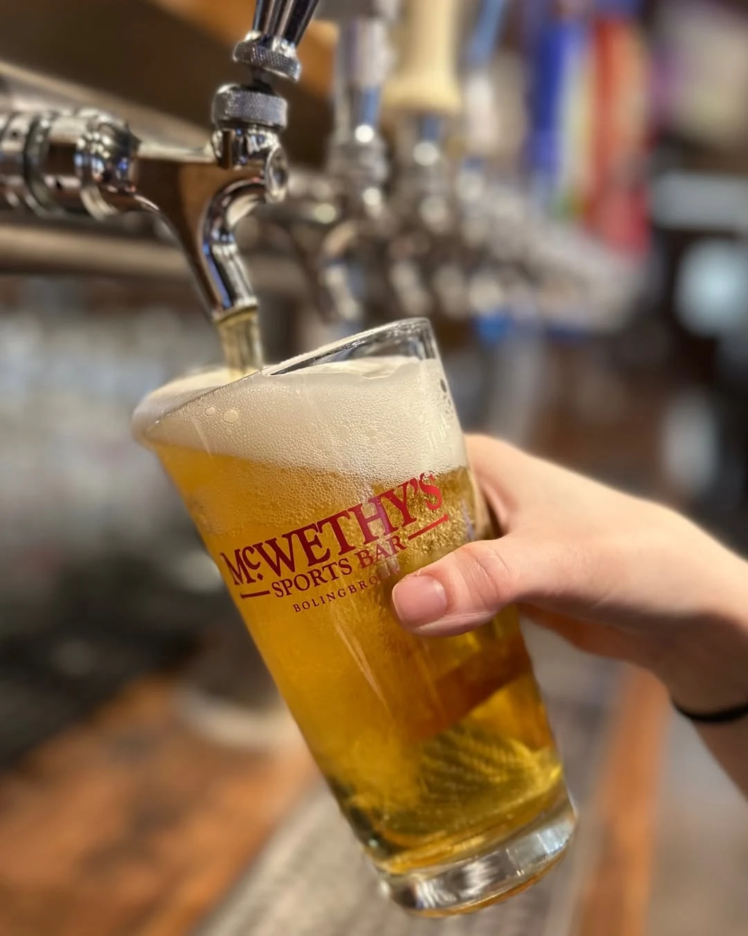 Hospitality beverage photography of McWethy's branded beer being poured from tap